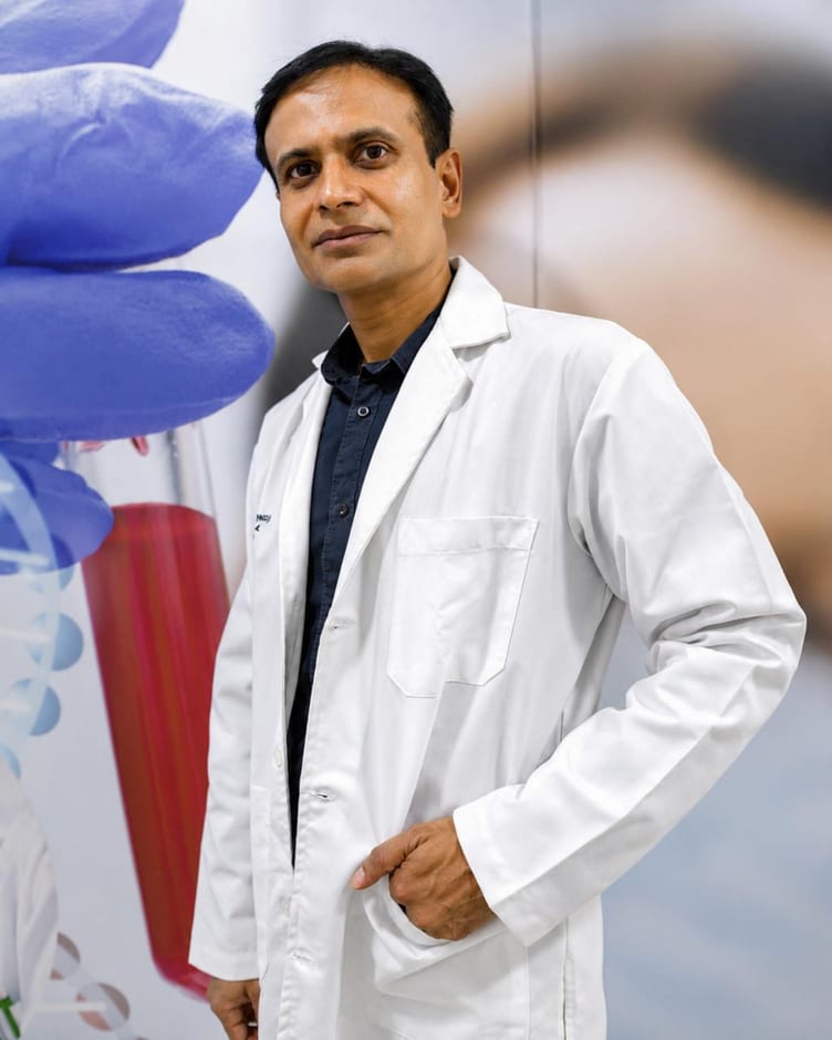 Dr Sandeep Mahapatra standing in a white coat at the Derma Solutions clinic